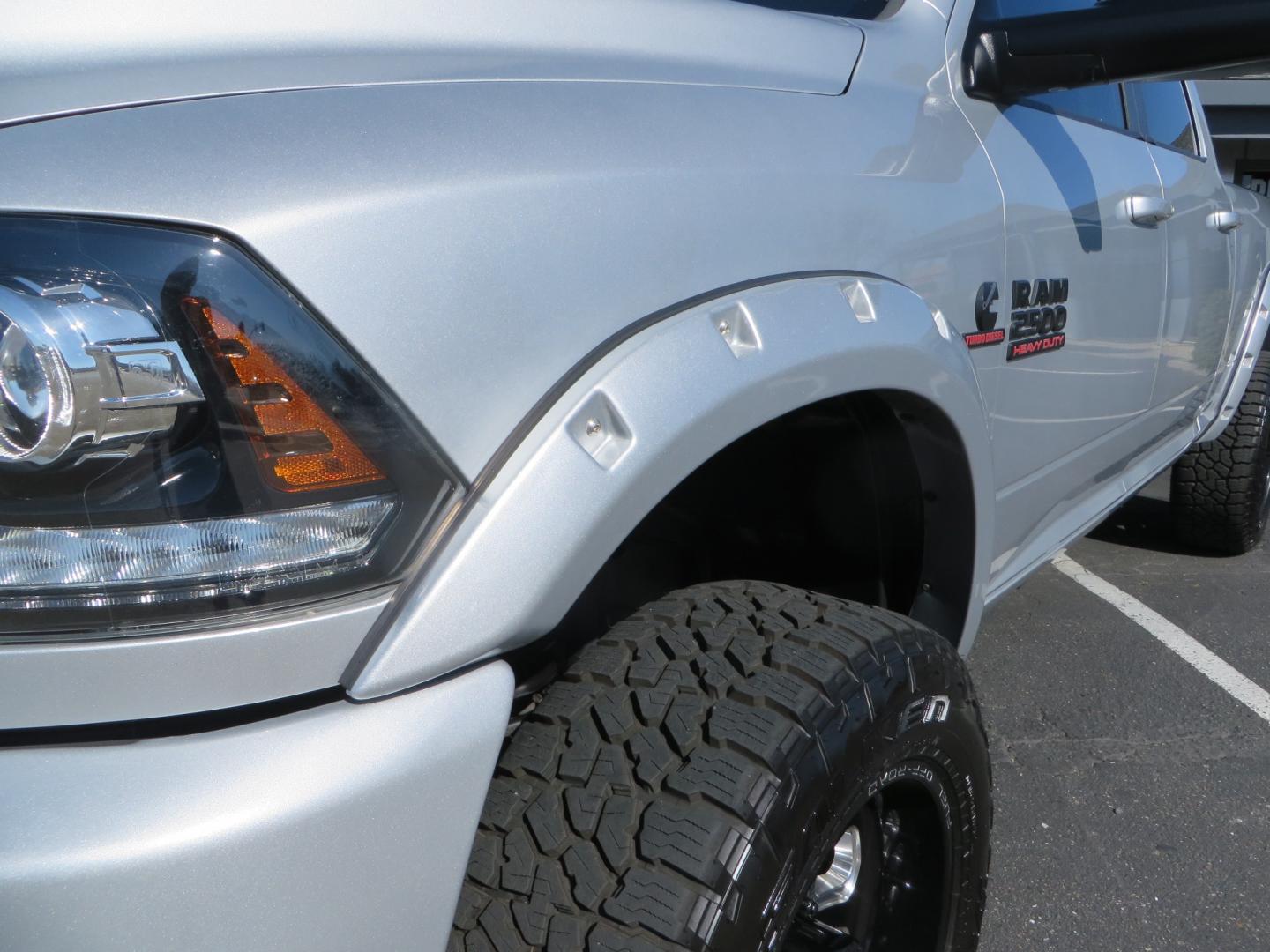 2016 SILVER /BLACK RAM 2500 Laramie Crew Cab SWB 4WD (3C6UR5FL3GG) with an 6.7L L6 OHV 24V TURBO DIESEL engine, 6A transmission, located at 2630 Grass Valley Highway, Auburn, CA, 95603, (530) 508-5100, 38.937893, -121.095482 - Leveled Ram sitting on Fuel Offroad wheels, Falken Wildpeak AT tires, Amp Power steps, Rolling Bed cover, Color matched fender flares, and window tint. - Photo#9